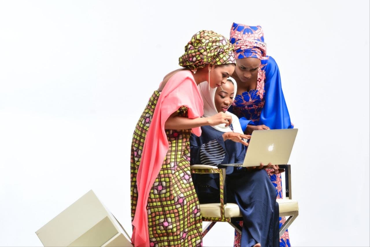 Women collaborating around a laptop